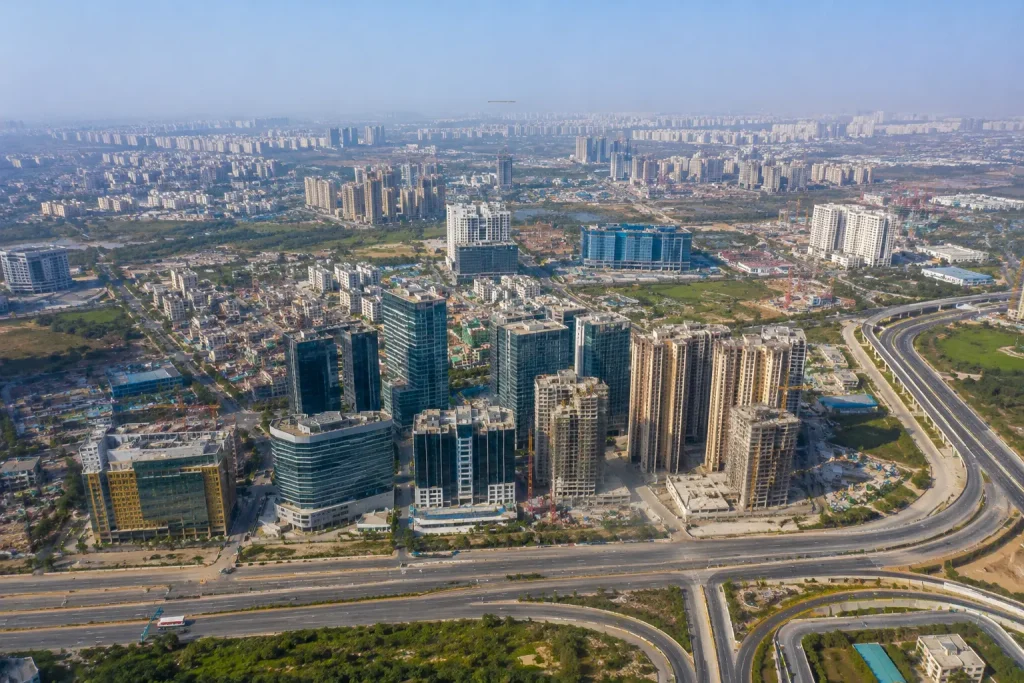 Aerial drone view of Hyderabad Financial District, Kokapet, Nanakramguda, and Gachibowli showcasing luxury residential projects, commercial towers, and modern road infrastructure.